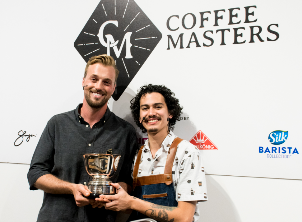Reef Bessette and Remy Molina holding a trophy at the Los Angeles Coffee Festival.